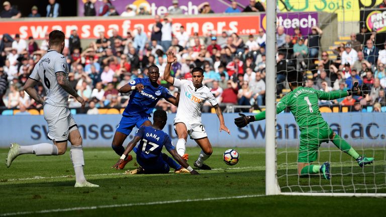 Kyle Naughton (2nd r) scores an own goal to put Everton in the lead during the Premier League match at the Liberty Stadium on April 14, 2018
