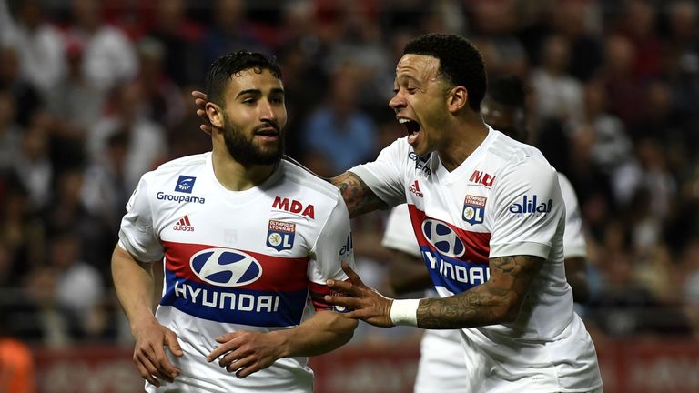 Lyon's French midfielder Nabil Fekir (L) is congratuled by teamate Lyon's Dutch forward Memphis Depay (R) after scoring during the French L1 football match between Dijon FCO and Olympique Lyonnais, on April 20, 2018, at the Gaston Gérard Stadium in Dijon, central France. 