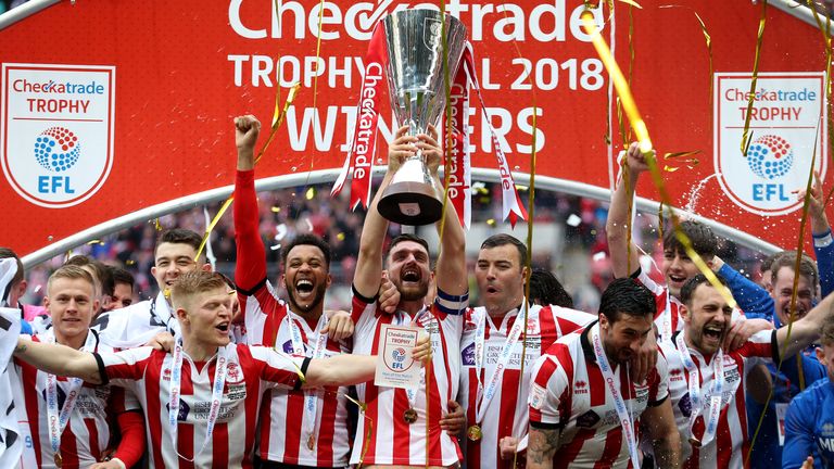Lincoln City Luke Waterfall (centre) and team-mates celebrate with the trophy after winning the Checkatrade Trophy final at Wembley        