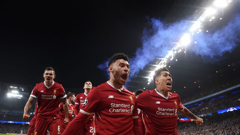 Alex Oxlade-Chamberlain and Roberto Firmino of Liverpool celebrate their sides first goal scored by Mohamed Salah during the Quarter Final Second Leg match between Manchester City and Liverpool at Etihad Stadium