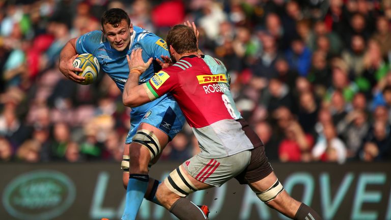 Jake Schatz of London Irish looks to hold off the tackle from Chris Robshaw of Harlequins