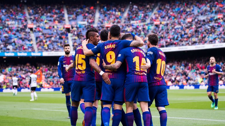 Luis Suarez celebrates with teammates after scoring the opening goal during the La Liga match between Barcelona and Valencia at Camp Nou on April 14, 2018