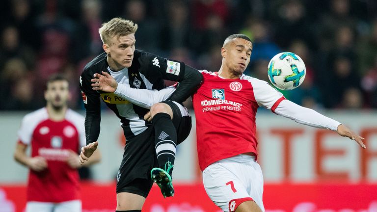 Moenchengladbach's Oscar Wendt jumps for a header with Robin Quaison in the stalemate with Mainz