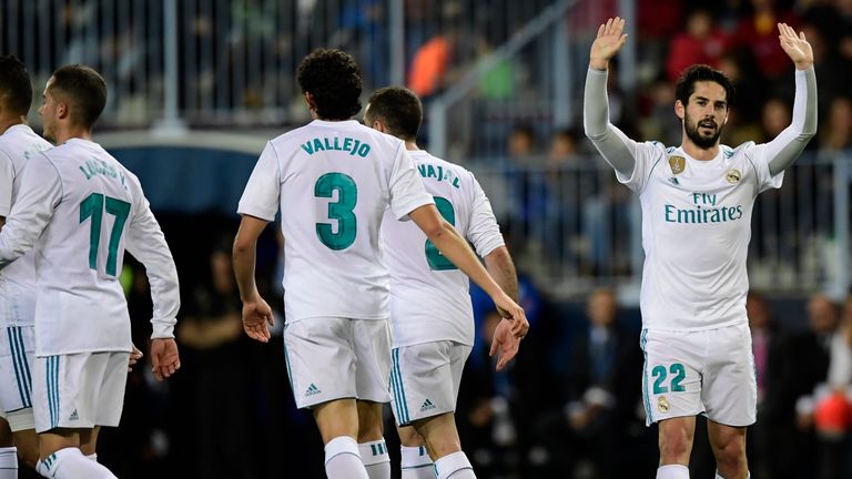 Real Madrid's Spanish midfielder Isco (R) celebrates a goal during the Spanish league football match between Malaga CF and Real Madrid CF at La Rosaleda stadium