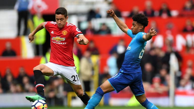 Manchester United's Ander Herrera vies with Arsenal's Reiss Nelson 