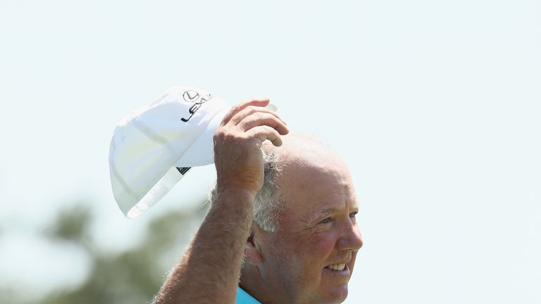 Mark O'Meara waves to the crowd on the 18th green during the first round of the 2018 Masters Tournament at Augusta National Golf Club