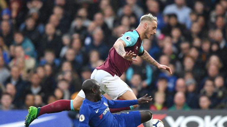 Marko Arnautovic is tackled by N'Golo Kante 