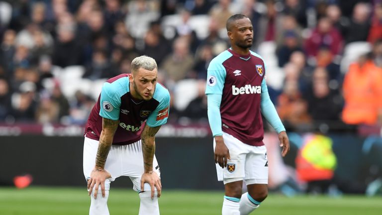 Marko Arnautovic and Patrice Evra look on during West Ham's 4-1 defeat to Man City