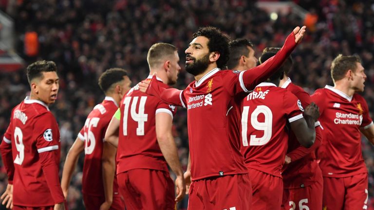 Mohamed Salah celebrates surrounded by teammates after scoring the opening goal during the UEFA Champions League quarter-final, first leg against Manchester City