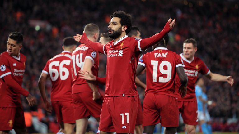 Liverpool's Mohamed Salah (centre) celebrates scoring his side's first goal of the game during the UEFA Champions League quarter-final, first leg match at Anfield
