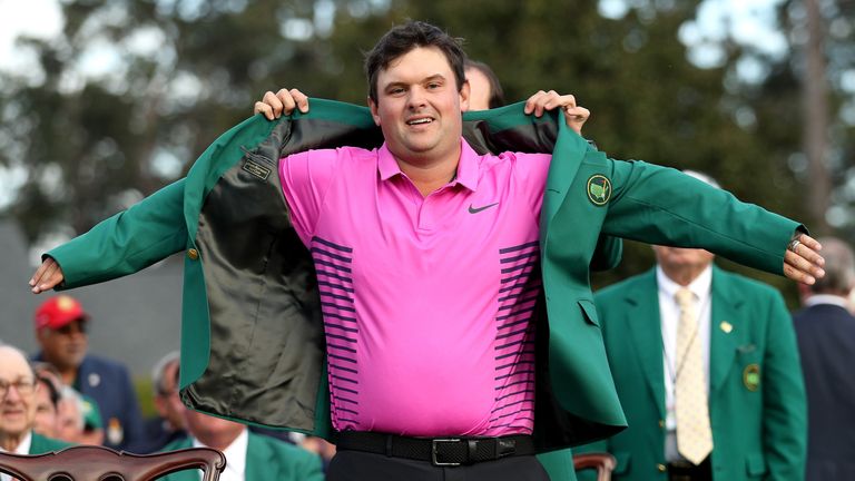 Patrick Reed of the United States is presented with the green jacket by Sergio Garcia of Spain during the Green Jacket Ceremony after winning the 2018 Masters Tournament at Augusta National Golf Club