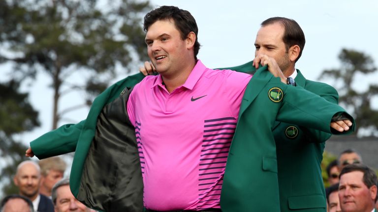 Patrick Reed is presented with the Green Jacket by Sergio Garcia