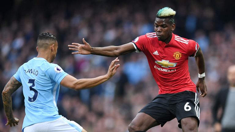 Danilo tackles Paul Pogba during the Premier League match between Manchester City and Manchester United at the Etihad Stadium