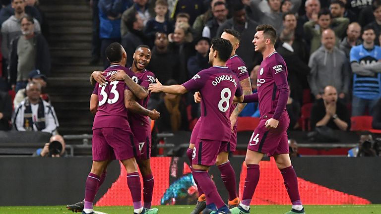 Manchester City's Raheem Sterling celebrates scoring his side's third goal of the game with teammates