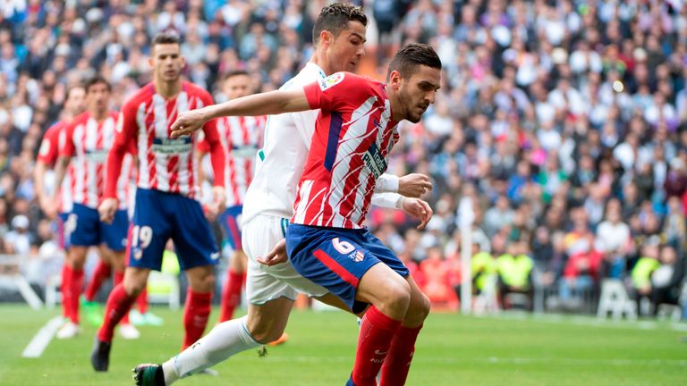 Real Madrid's Portuguese forward Cristiano Ronaldo (L) challenges Atletico Madrid's Spanish midfielder Koke