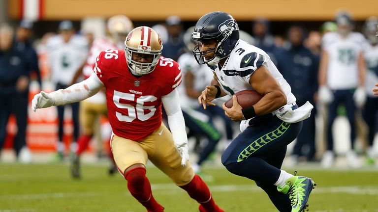 SANTA CLARA, CA - NOVEMBER 26: Quarterback Russell Wilson #3 of the Seattle Seahawks evades Reuben Foster #56 of the San Francisco 49ers at Levi's Stadium on November 26, 2017 in Santa Clara, California. (Photo by Lachlan Cunningham/Getty Images)