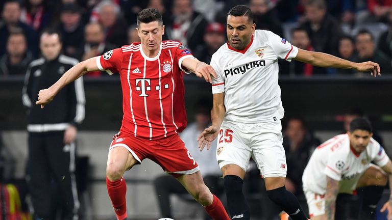 Robert Lewandowski and Gabriel Mercado in action during the Champions League tie between Bayern Munich and Sevilla