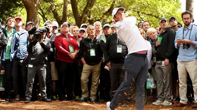 Rory McIlroy play his second shot from the pine straw on the first hole during the final round of the 2018 Masters Tournament at Augusta National Golf Club