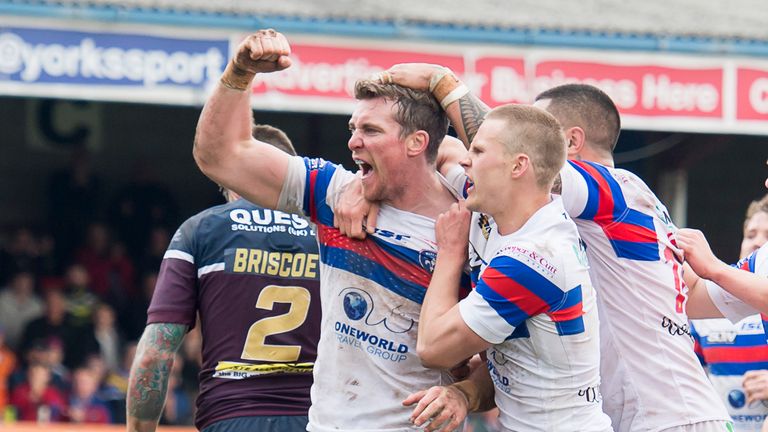 Matty Ashurst (left) celebrates after scoring Trinity's third try