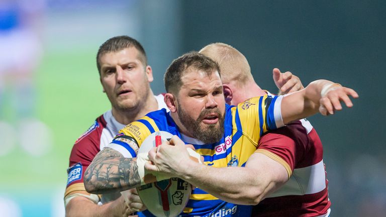Adam Cuthbertson is tackled by Wigan's Tony Clubb and Liam Farrell