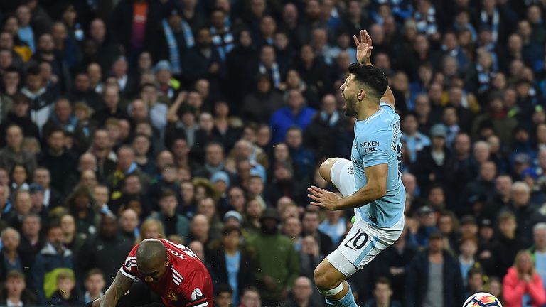 Man City's Sergio Aguero is tackled by Ashley Young of Man Utd