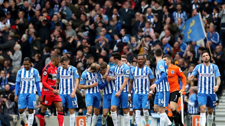 Brighton & Hove Albion's Solly March (centre) celebrates after his shot is deflected into his own net by Huddersfield Town goalkeeper Jonas Lossl