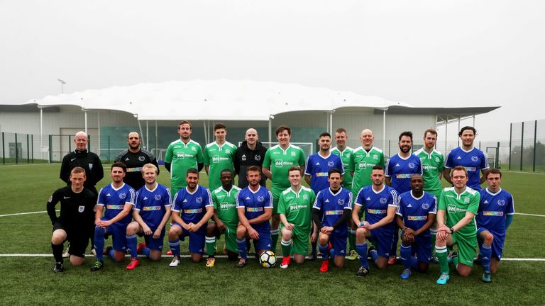 Stonewall FC and UK Parliamentary Football Club players pose for a photo at St George's Park