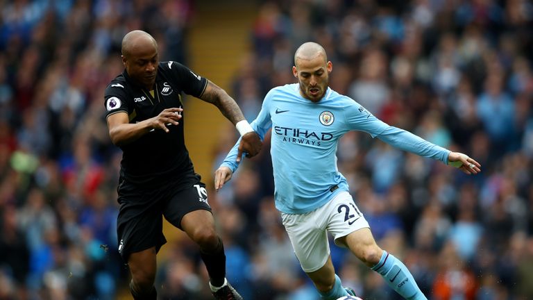 Andre Ayew and David Silva battle for the ball