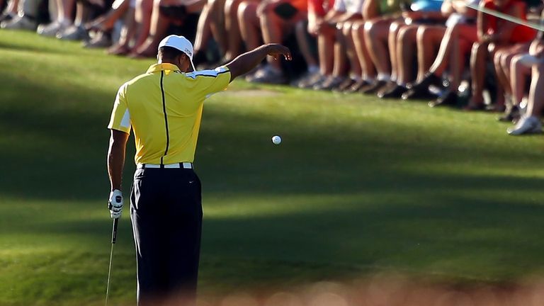 Tiger Woods of the United States drops his ball after he hits it into the water on the 15th hole during the second round of the 2013 Masters Tournament at Augusta National Golf Club 