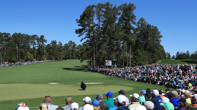 Tiger Woods lines up a putt on the second green during round one of the 2018 Masters Tournament at Augusta