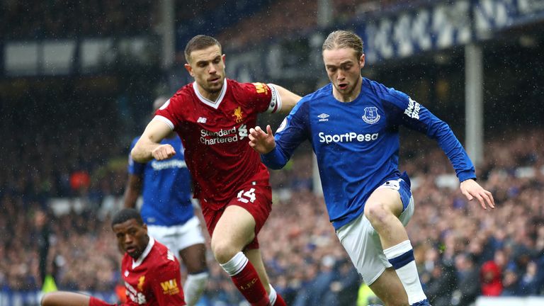 Tom Davies runs with the ball under pressure from Jordan Henderson during the Premier League match between Everton and Liverpool