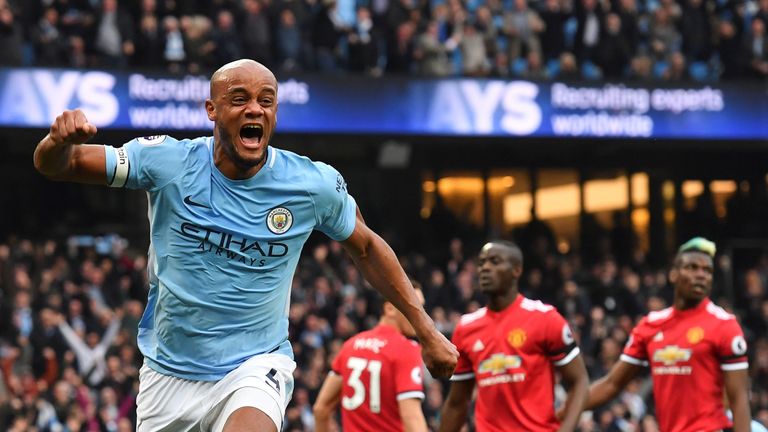 Vincent Kompany celebrates scoring the opening goal of the game as Manchester United players look on