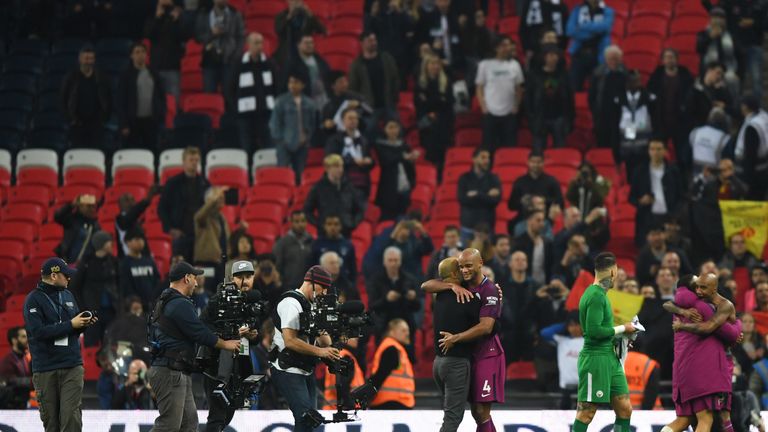 Josep Guardiola, Manager of Manchester City embraces Vincent Kompany of Manchester City after the Premier League match between Tottenham Hotspur and Manchester City at Wembley Stadium on April 14, 2018 in London, England.
