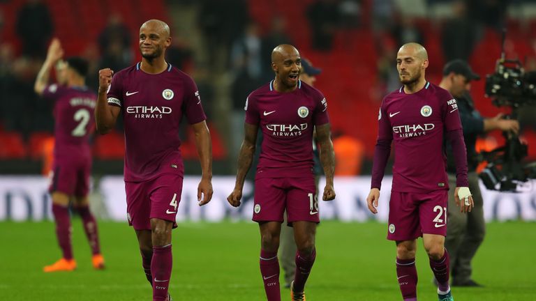 Vincent Kompany of Manchester City celebrates with Fabian Delph and David Silva of Manchester City after the Premier League match between Tottenham Hotspur and Manchester City at Wembley Stadium on April 14, 2018 in London, England