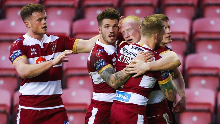Picture by Alex Whitehead/SWpix.com - 20/04/2018 - Rugby League - Betfred Super League - Wigan Warriors v Castleford Tigers - DW Stadium, Wigan, England - Wigan's Liam Farrell celebrates his try with Sam Tomkins, Oliver Gildart and Joe Burgess.