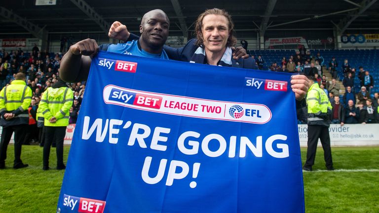 Wycombe Wanderers manger Gareth Ainsworth and striker Adebayo Akinfenwa celebrate promotion to League One (credit: Sky Bet/JMP)