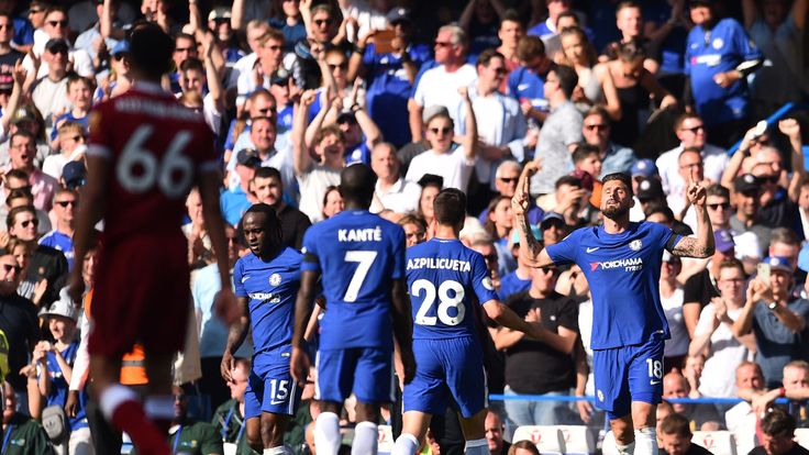 Chelsea's French striker Olivier Giroud (R) celebrates scoring the opening goal with teammates during the English Premier League football match between Chelsea and Liverpool at Stamford Bridge