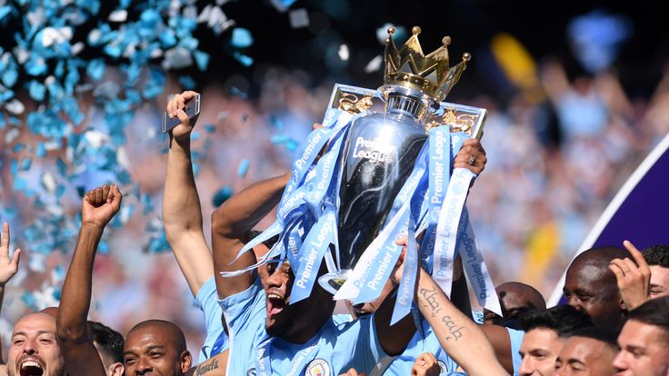 Vincent Kompany lifts the Premier League trophy as Manchester City celebrate winning the Premier League at the Etihad Stadium