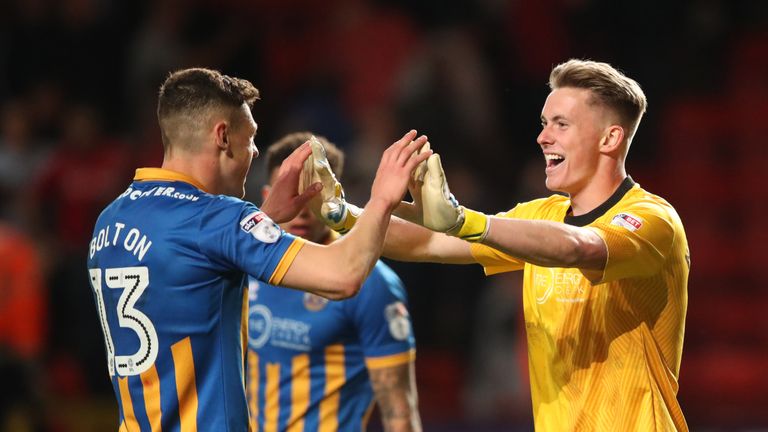 Shrewsbury Town's James Bolton celebrates with team-mate Dean Henderson after the final whistle