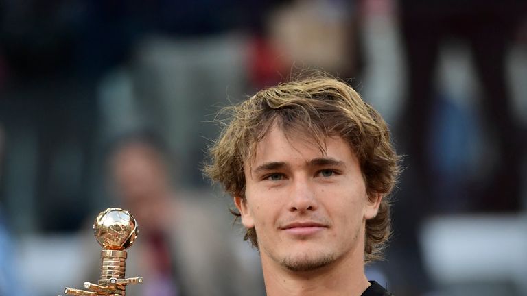 Germany's Alexander Zverev poses with his trophy after defeating Austria's Dominic Thiem during their ATP Madrid Open final tennis match at the Caja Magica in Madrid on May 13, 2018.