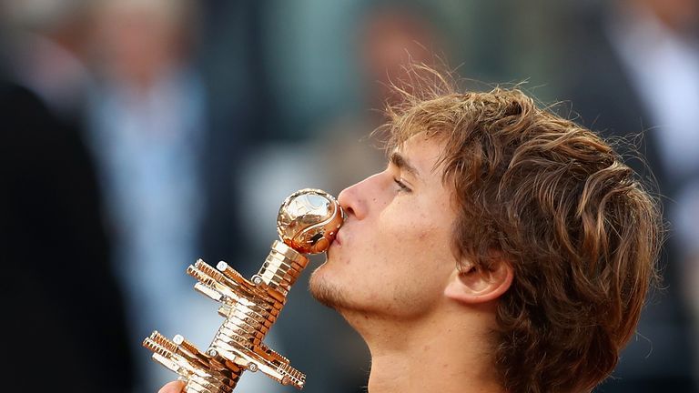 Alexander Zverev of Germany kisses his winners trophy after his straight sets victory against Dominic Thiem of Austria in the mens final during day nine of the Mutua Madrid Open tennis tournament at the Caja Magica on May 13, 2018 in Madrid, Spain.