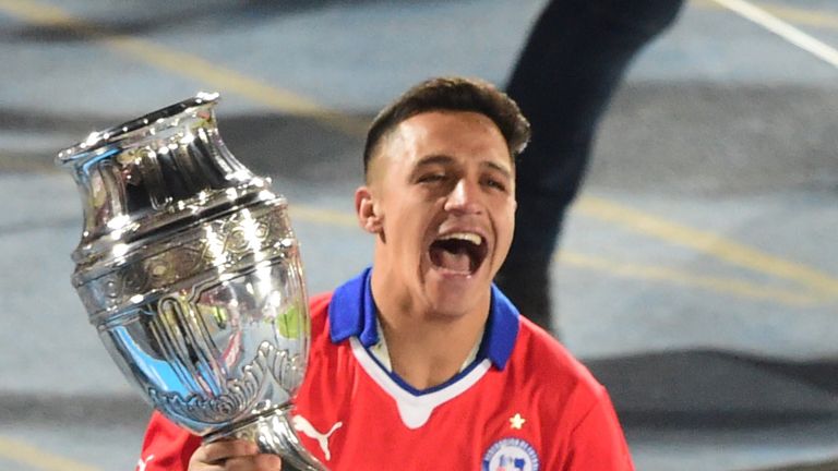 Alexis Sanchez celebrates with the trophy after winning the Copa America with Chile