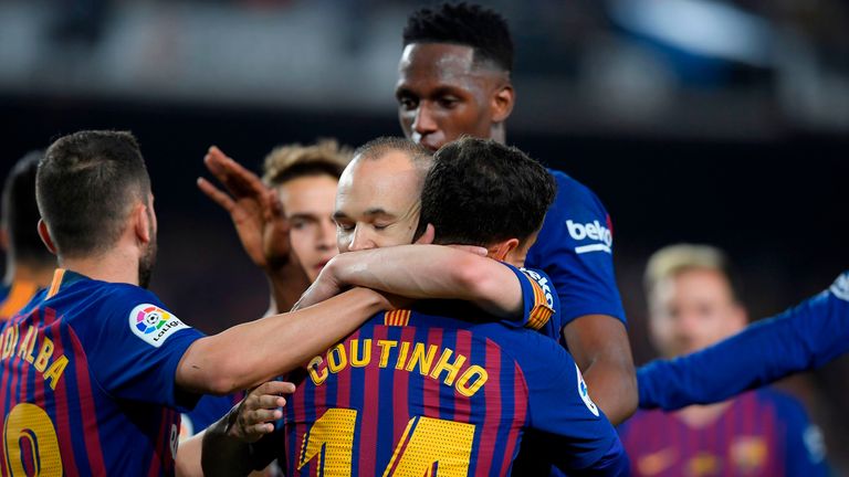 Andres Iniesta celebrates with Philippe Coutinho after the Brazilian's goal for Barcelona against Real Sociedad