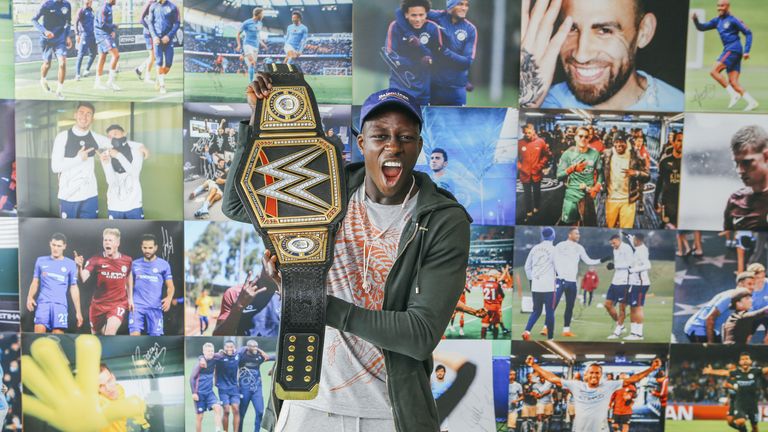 Benjamin Mendy poses with Manchester City's customised WWE title belt