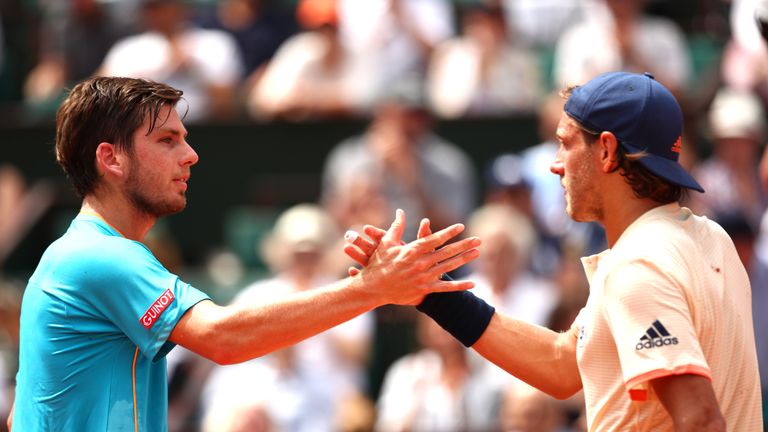 Cameron Norrie of Great Britain congratulates Lucas Pouille of France on victory following the mens singles second round match during day five of the 2018 French Open at Roland Garros on May 31, 2018 in Paris, France.