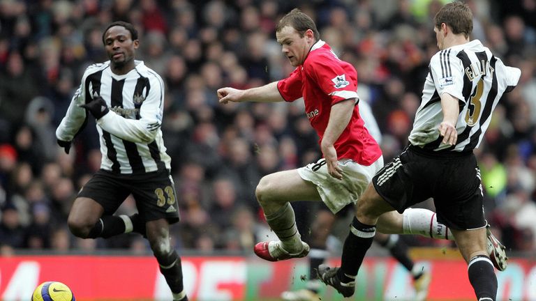 Celestine Babayaro in action for Newcastle United as Wayne Rooney runs through for Manchester United