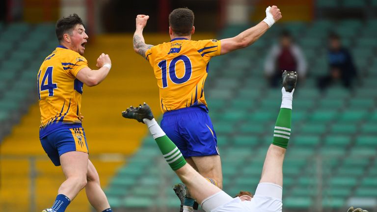 Kieran Malone of Clare, right, celebrates scoring his side's first goal.