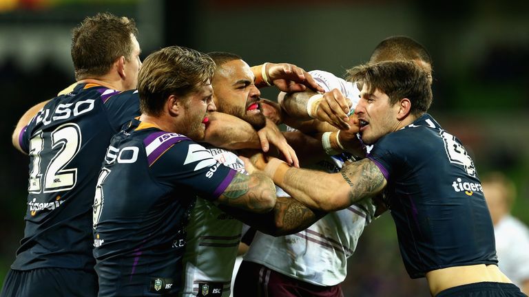 Curtis Scott of the Melbourne Storm and Dylan Walker of the Manly Sea Eagles wrestle during the round 11 NRL match between the Melbourne Storm and the Manly Sea Eagles