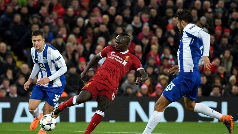 Sadio Mane shoots under pressure from Diogo Dalot (L) and Diego Reyes during the UEFA Champions League Round of 16, Second Leg match between Liverpool and FC Porto at Anfield on March 6, 2018