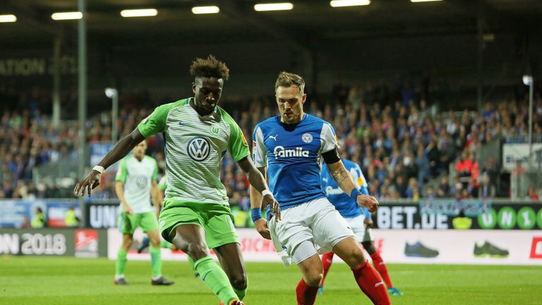 Divok Origi vies with Rafael Czichos during the relegation play-off 